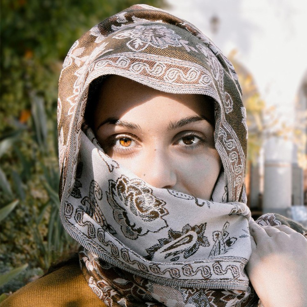 A person in a Jacquard Hijab with brown and beige patterns A person in a Jacquard Hijab with brown and beige patterns